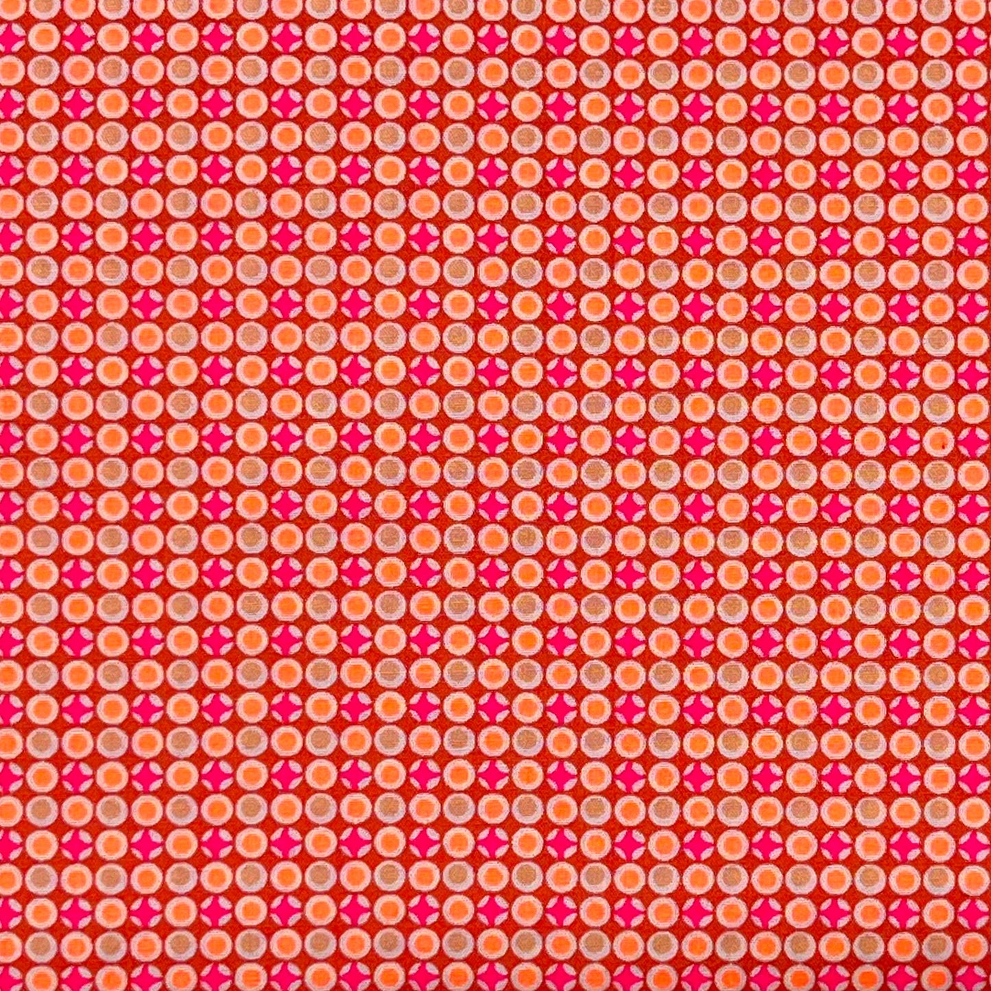 Tessuto fantasia geometrica con pois arancioni e fucsia