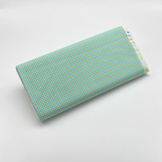 Tessuto fantasia geometrica con pois arancioni e giallo fluo