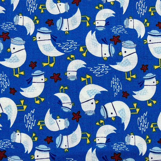 Tessuto a fantasia con gabbiani su sfondo blu azzurro intenso