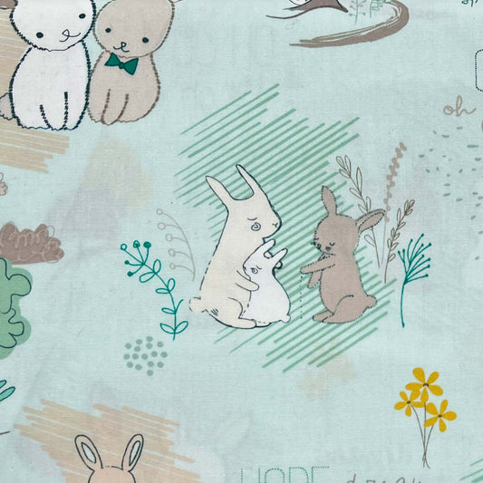 Tessuto a fantasia con coniglietti su sfondo verde acqua
