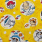 Tessuto a sfondo giallo con disegni giapponesi